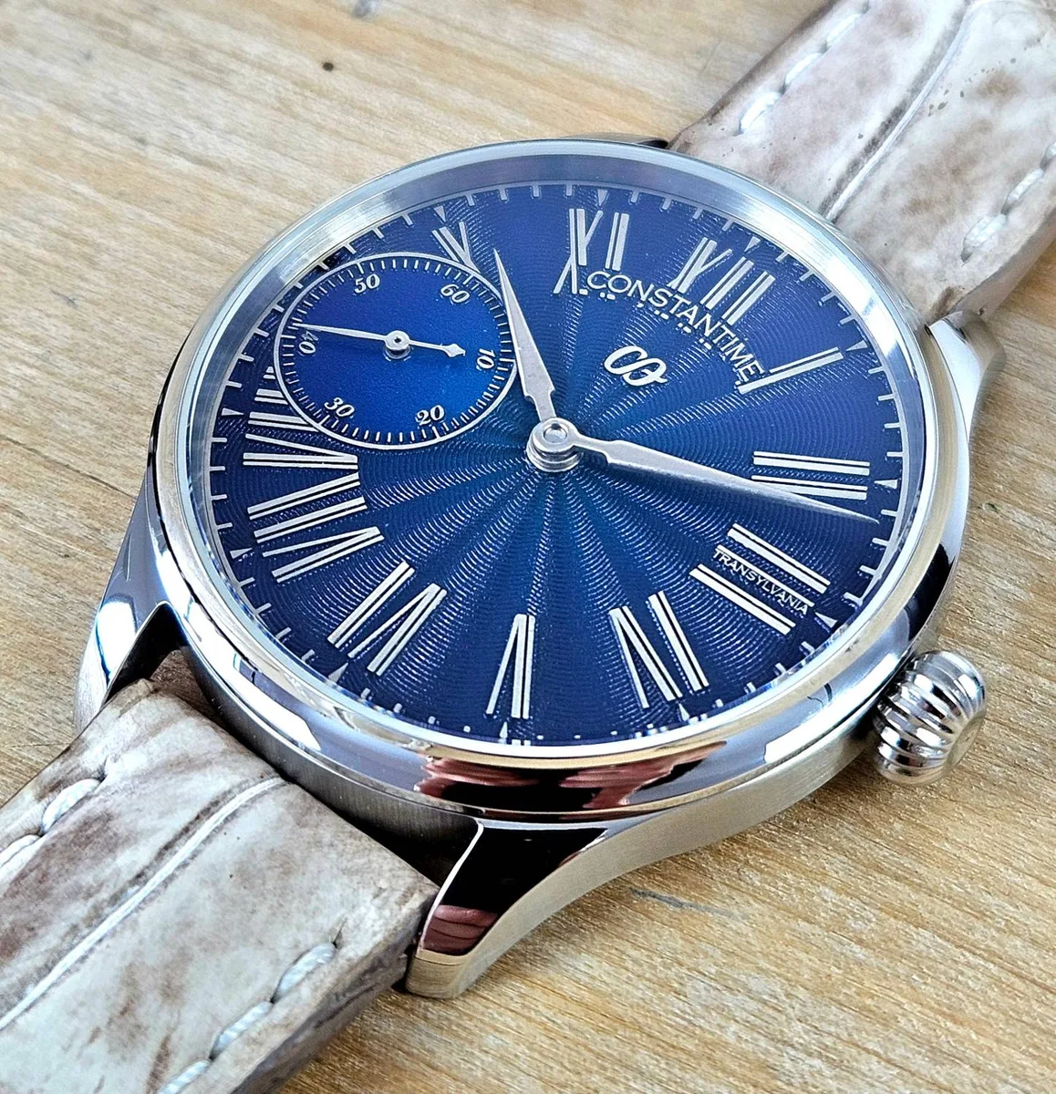 CONSTANTIME Genesis at an angle, showing the blue patterned dial, Roman numerals, sword hands and onion crown